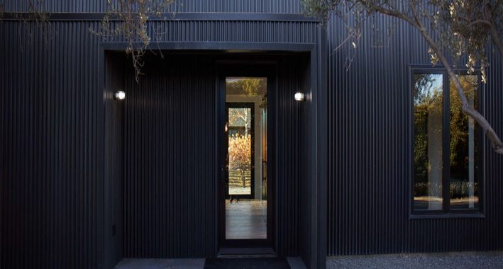 Modern guest house front door view through